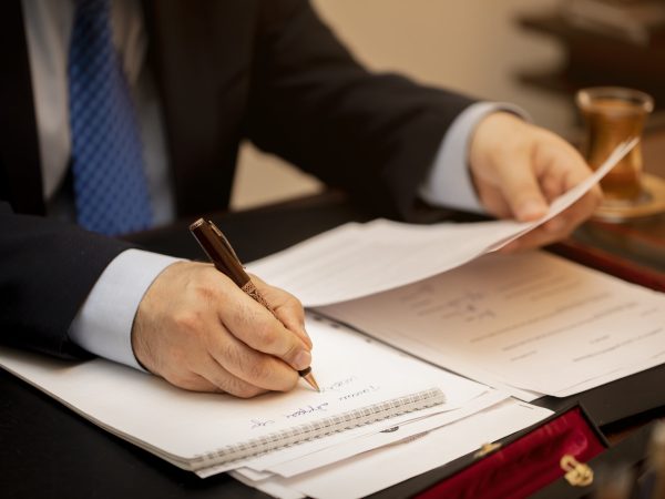 Businessman signing important contract papers. High quality photo
